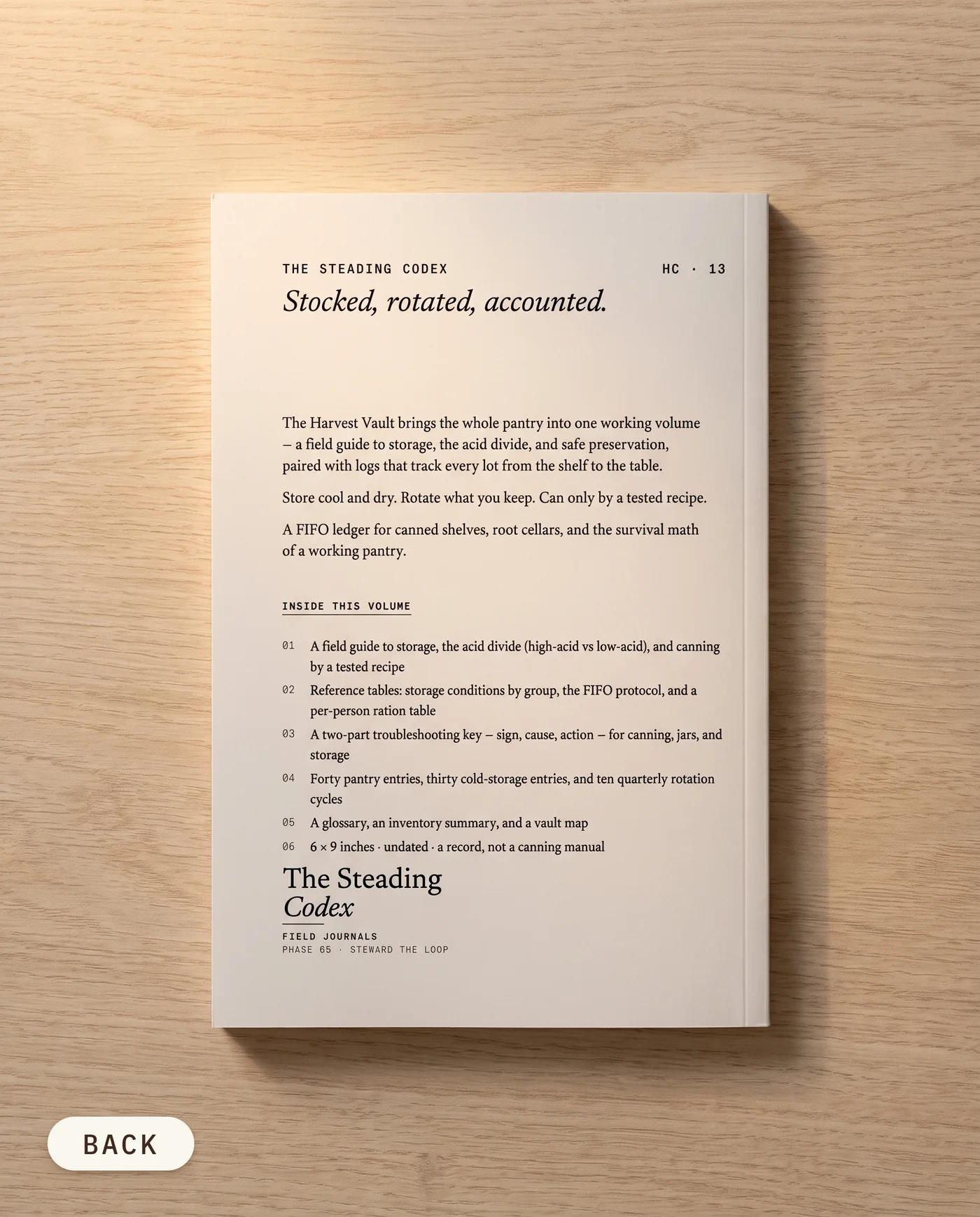 The Harvest Vault pantry and food storage journal — back cover on an oak table