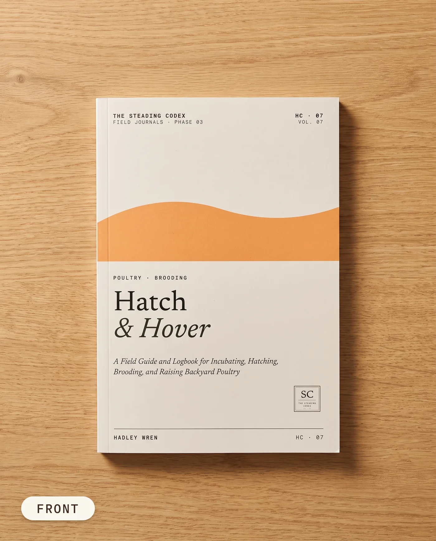 Hatch & Hover poultry hatching journal — front cover on an oak table