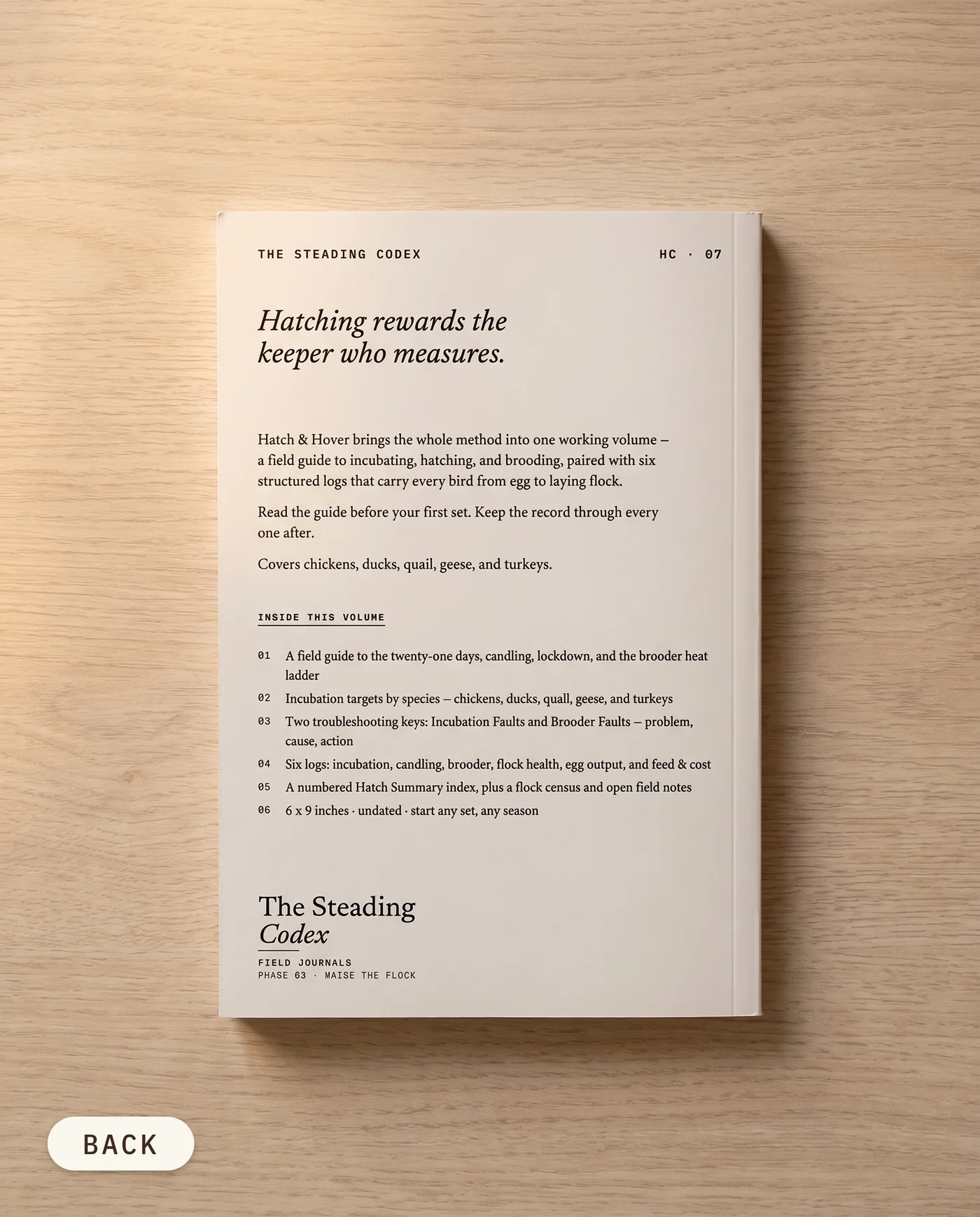 Hatch & Hover poultry hatching journal — back cover on an oak table