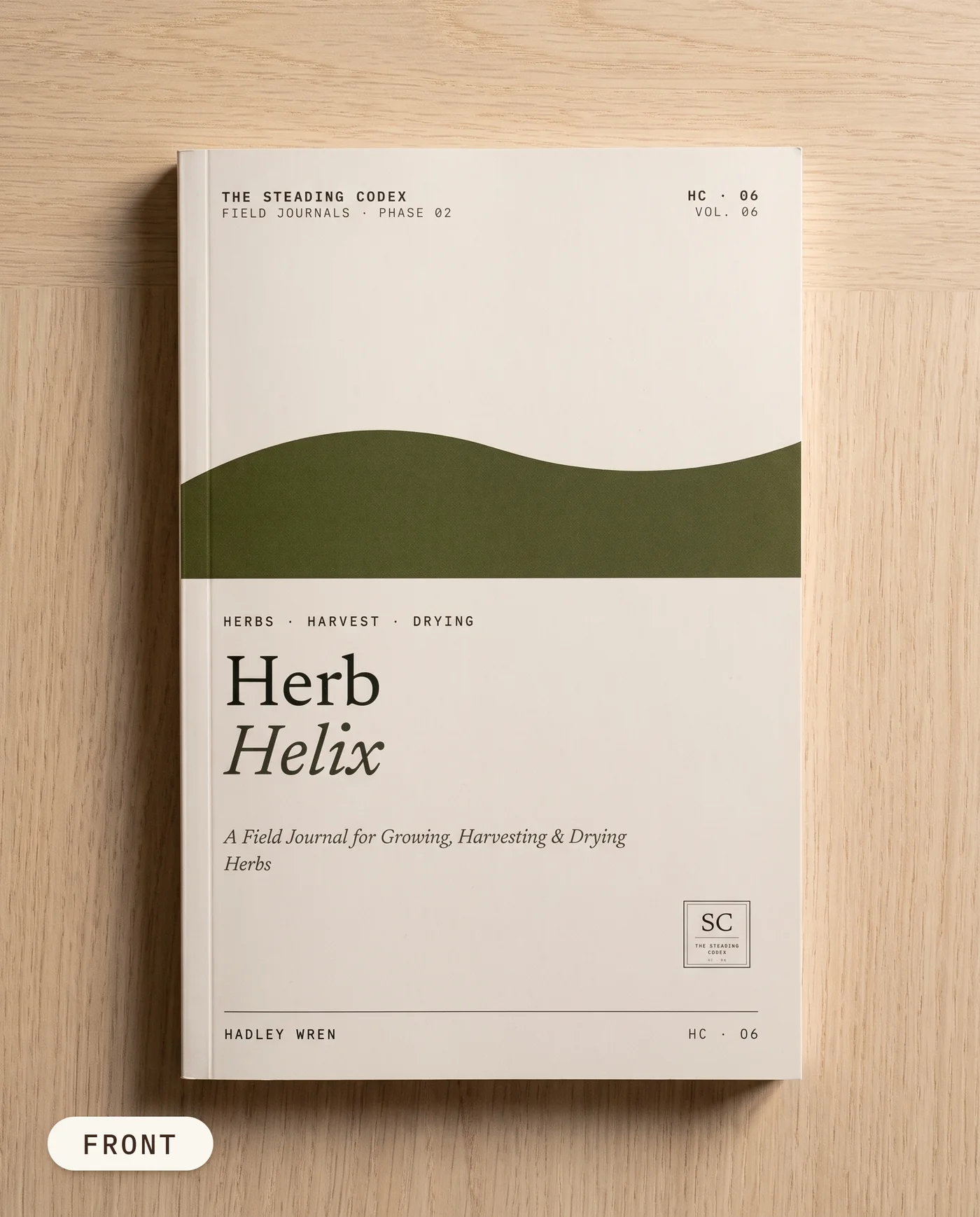 Herb Helix herb growing journal — front cover on an oak table