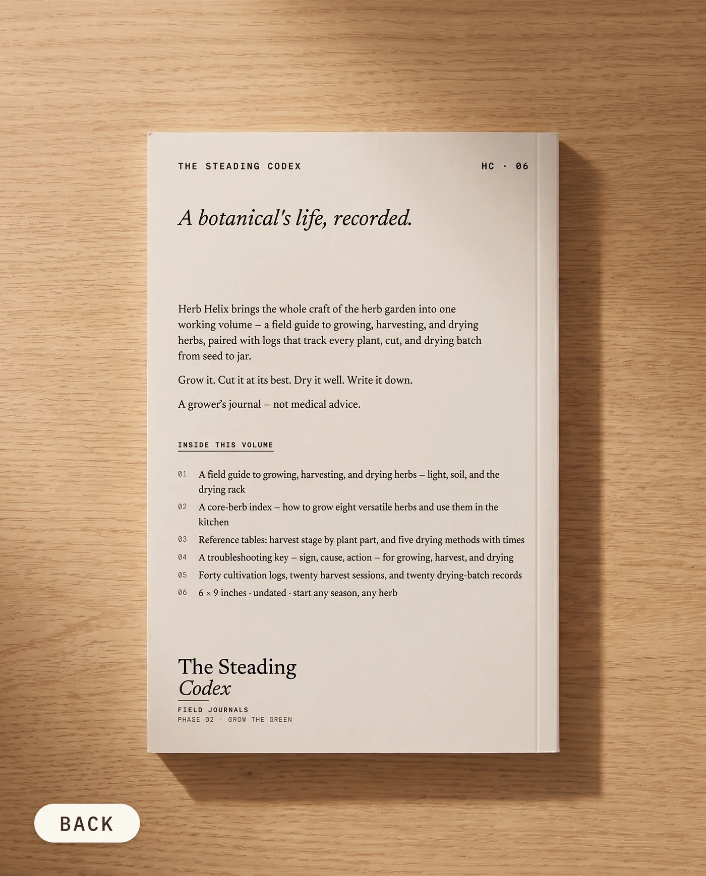 Herb Helix herb growing journal — back cover on an oak table