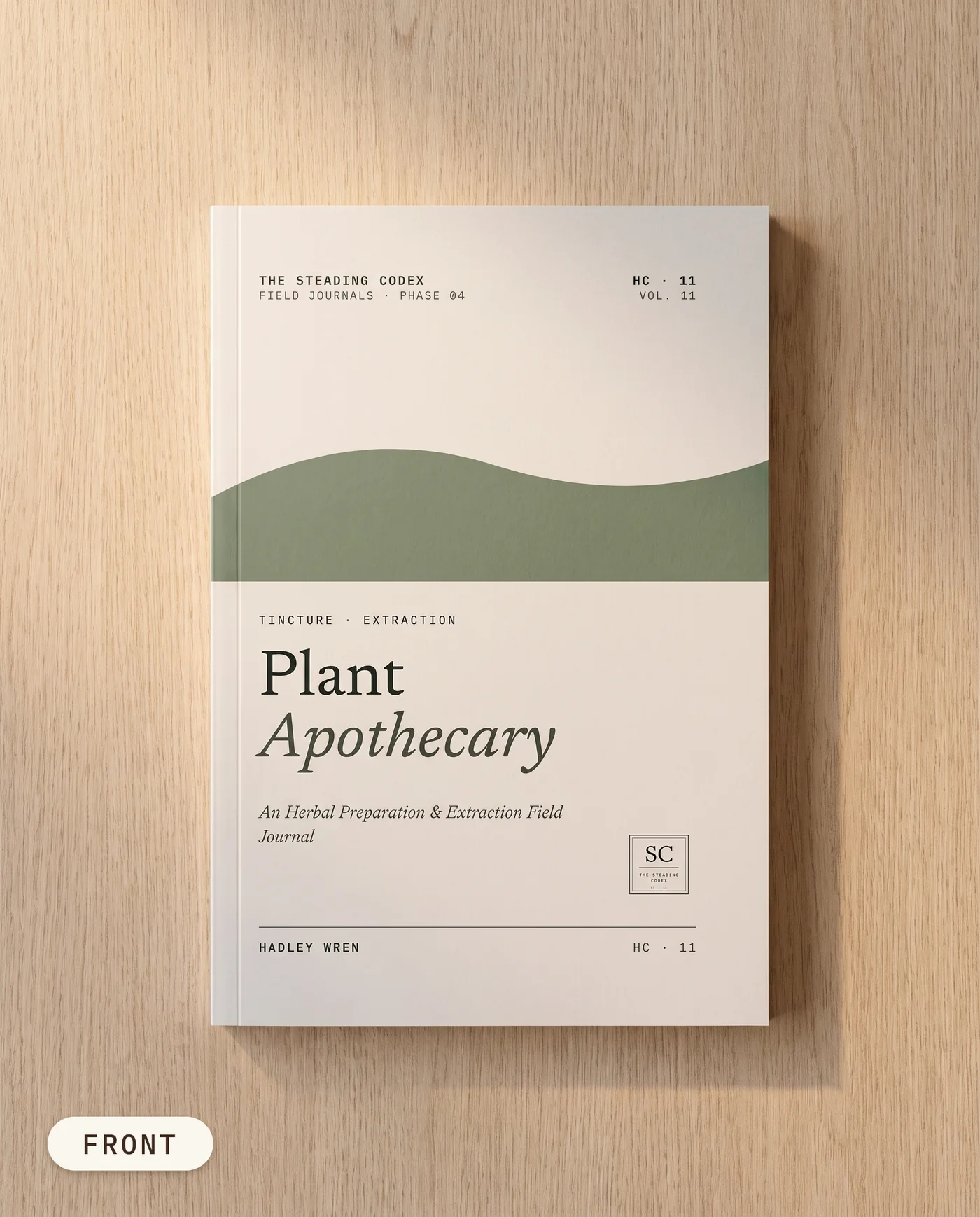 Plant Apothecary herbal preparation journal — front cover on an oak table