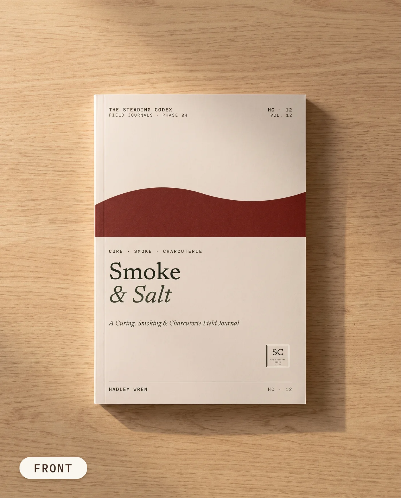 Smoke & Salt curing and smoking journal — front cover on an oak table