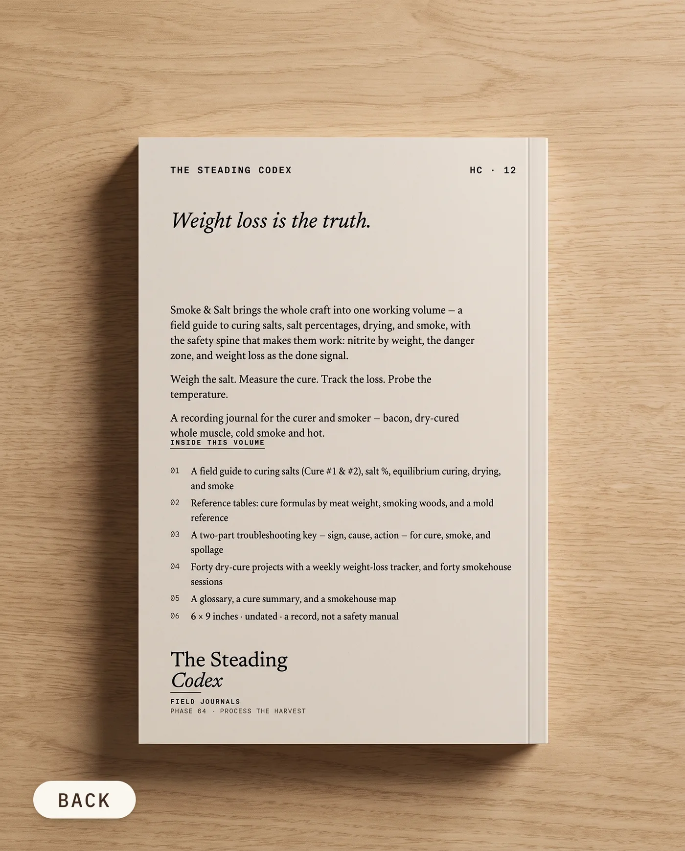 Smoke & Salt curing and smoking journal — back cover on an oak table