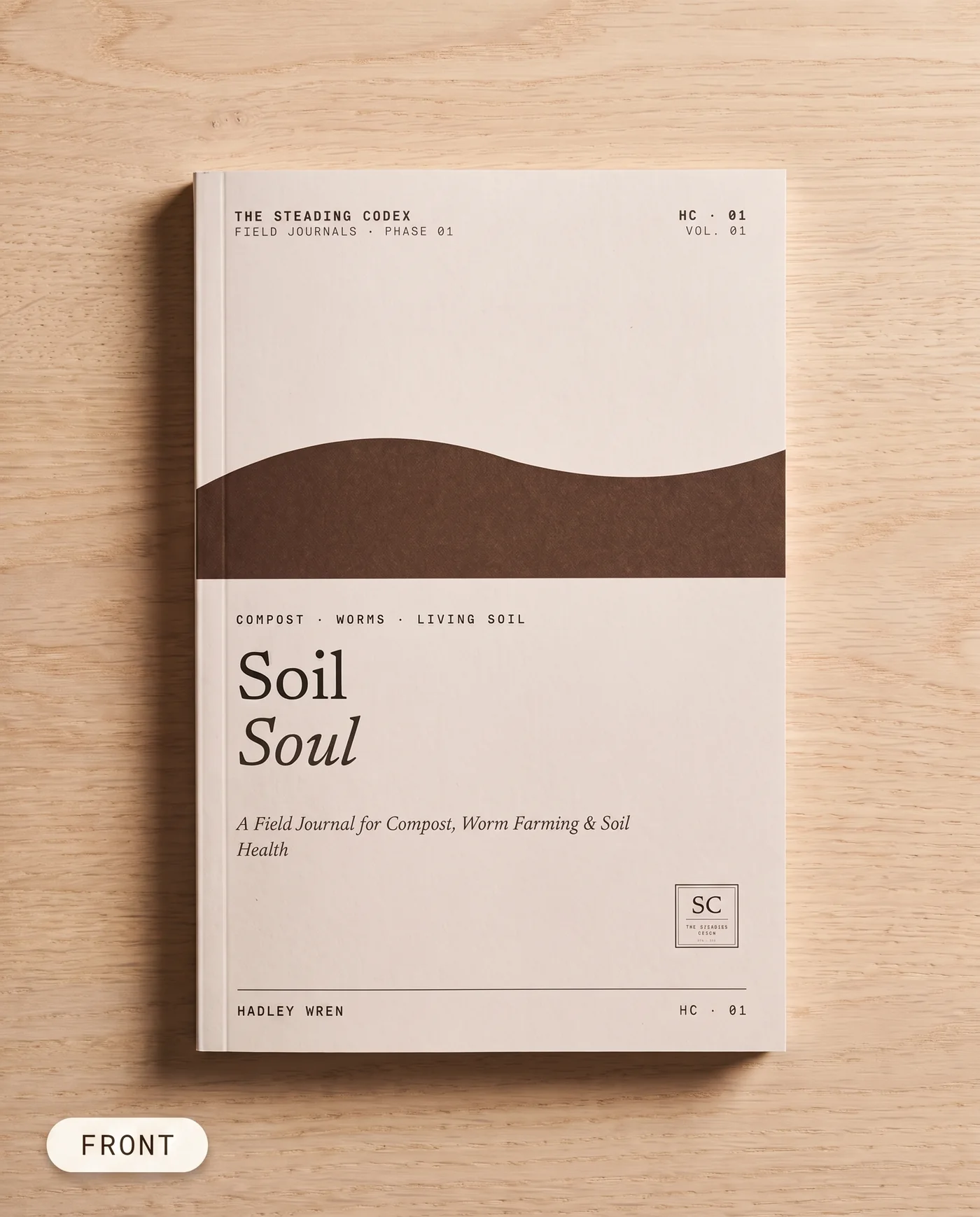 Soil Soul compost journal — front cover on an oak table
