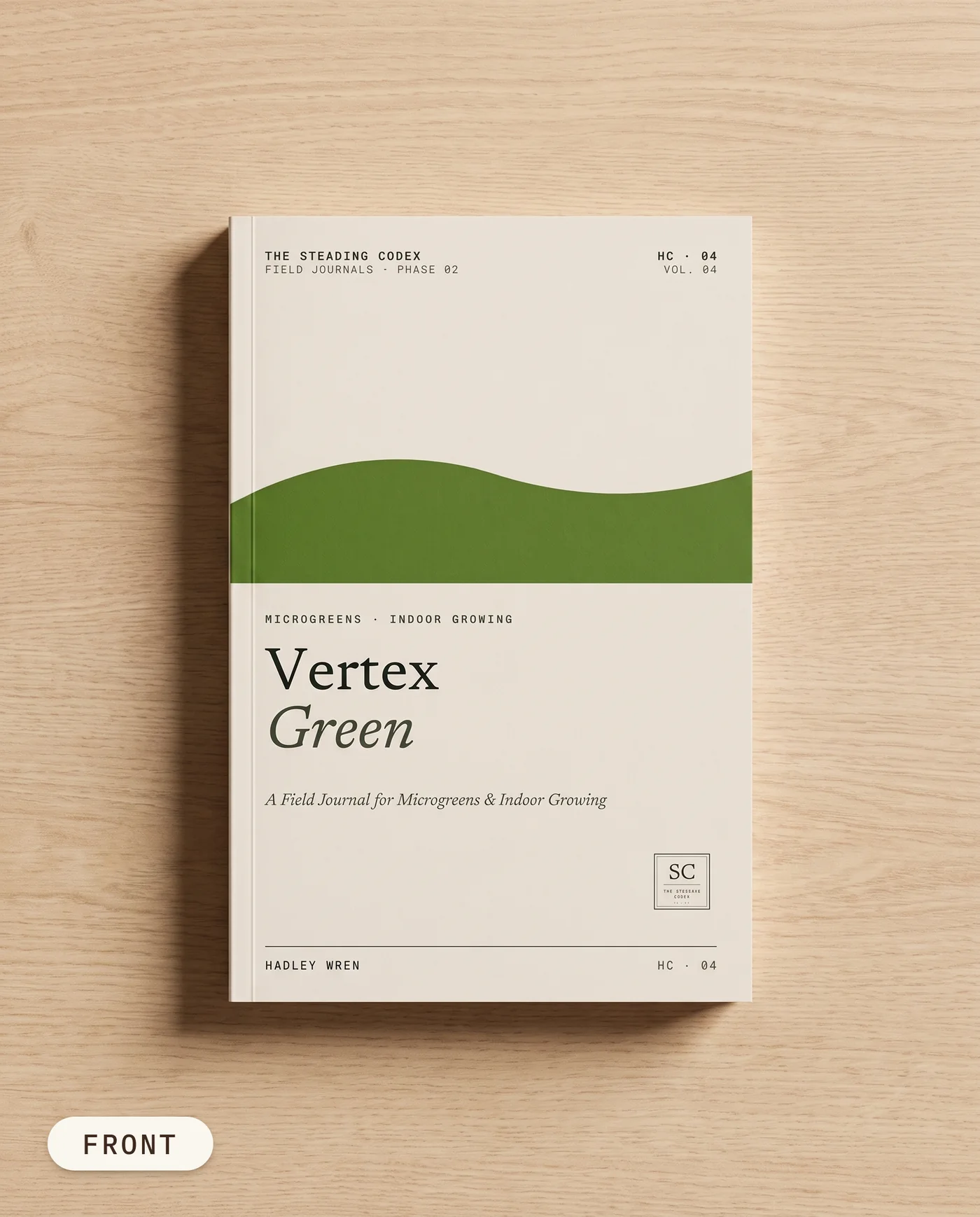 Vertex Green microgreens journal — front cover on an oak table